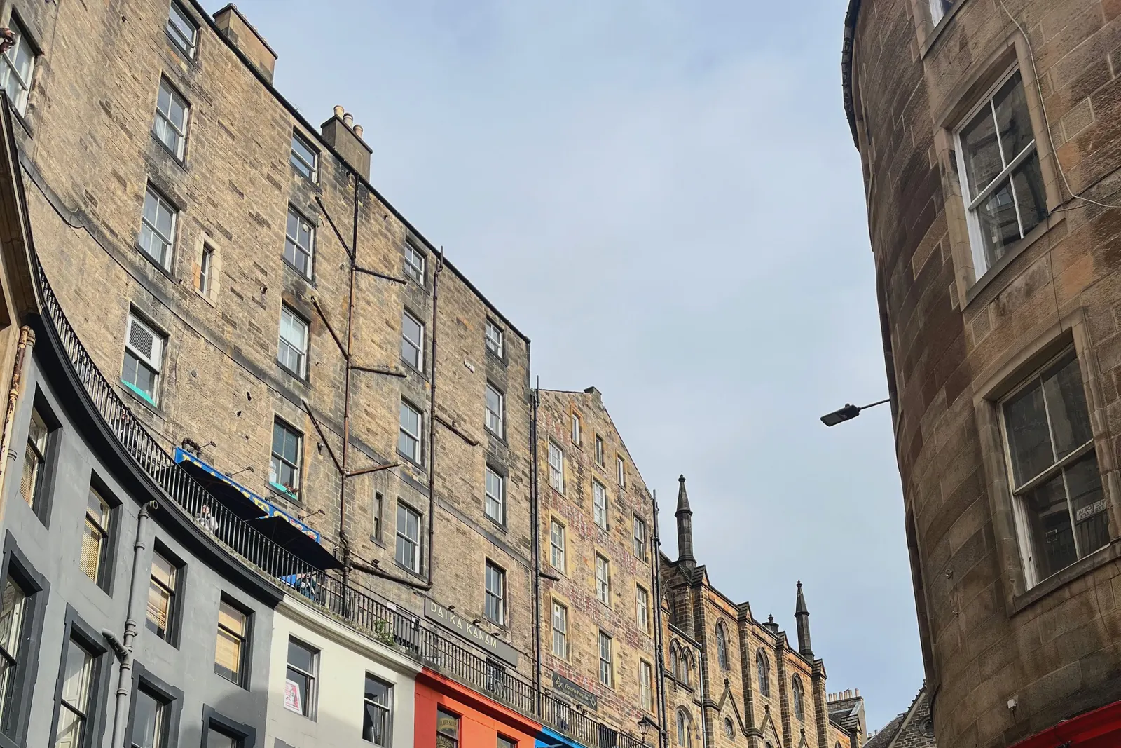 Victoria Street in Edinburgh, the painted shopfronts curving up the hill.